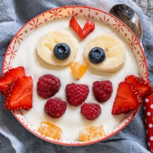 A variety of high-protein snacks for kids including bars, shakes, and fruits.