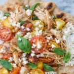 Crispy pita with chicken and feta served with tzatziki sauce and herbs.