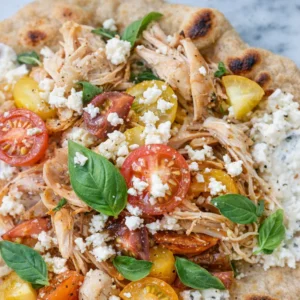 Crispy pita with chicken and feta served with tzatziki sauce and herbs.